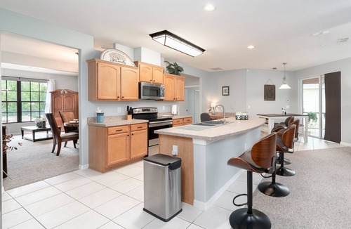 Wedgefield House | A peaceful tropical oasis with a large saltwater pool and spa hot tub.