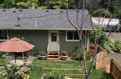 Veneta Apartment | A waterfall, bountiful gardens and the sound of birds, fenced and pet friendly!