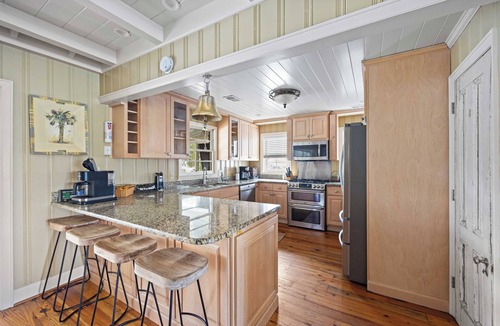 Litchfield by the Sea House | Beach House on Tidal Creek, Dock, Screen Porch, Easy Walk to Beach, Dog Friendly