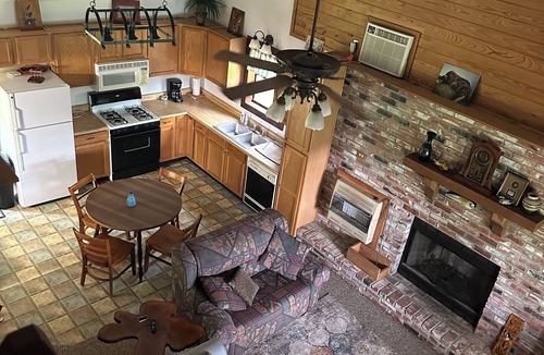Longleaf Cabin | Cozy Cabin setting behind a 1 1/2 acre pond that is lined with Cypress Trees.