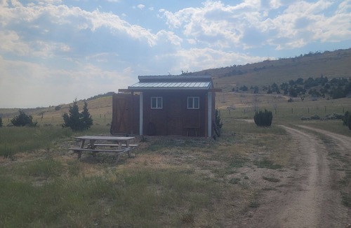 Manhattan Cabin | GRIZZLY ROCK RANCH Rustic Tiny Log Cabin Glamping and Horseback Riding Available