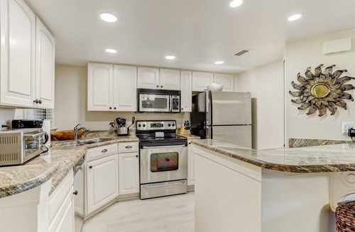 Amelia City Condo | Ground level, patio walkout - Oceanfront condo with gorgeous interior & Pool!