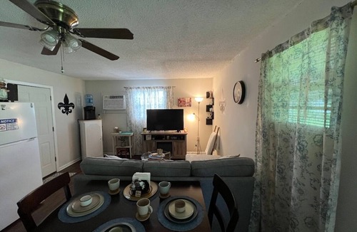 Lake Charles House | Indulge in stunning vistas from the porch, complemented by essential amenities for a cozy