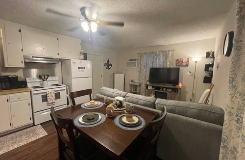 Lake Charles House | Indulge in stunning vistas from the porch, complemented by essential amenities for a cozy