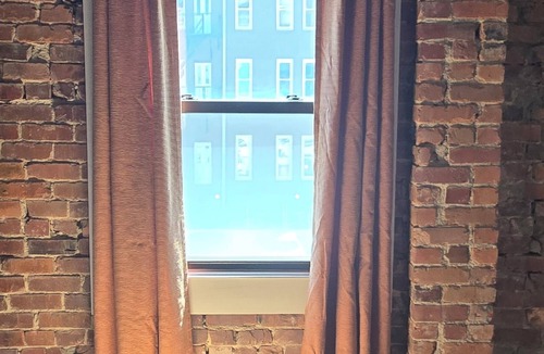 Monroe Ward Apartment | Large 1-bedroom apt with tall ceilings, brick walls, large tv, modern bathroom