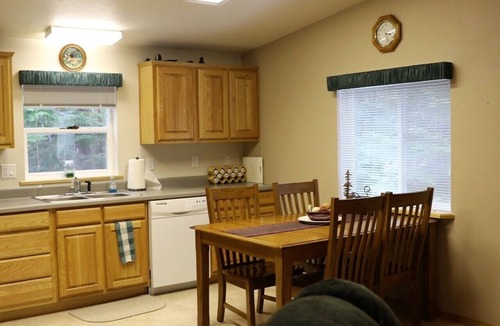 Priest River House | Located in a private wooded area with a lovely creekfront trail to explore.