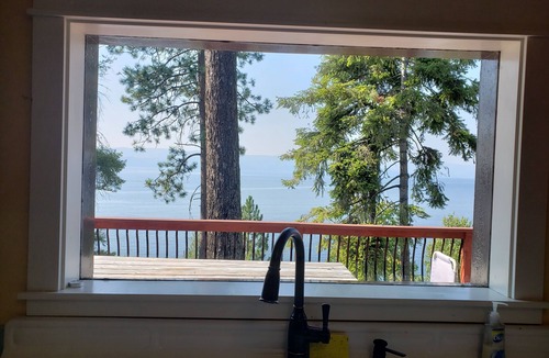 Bigfork House | Peaceful home enveloped in a quiet, scenic landscape adjacent to a rocky beach.