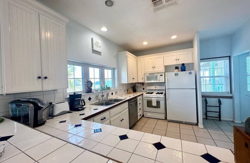 Sand Point House | "Prime coastal retreat just steps from the beach! Unwind by the community pool or ride the waves for the ultimate seaside escape."