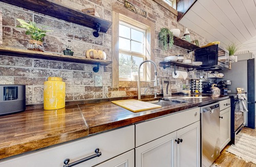 Evergreen House | Rustic getaway with fireplace, patio area, board games, full kitchen, & TV