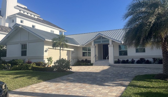 Four bedroom home directly across the street from Vanderbilt Beach!